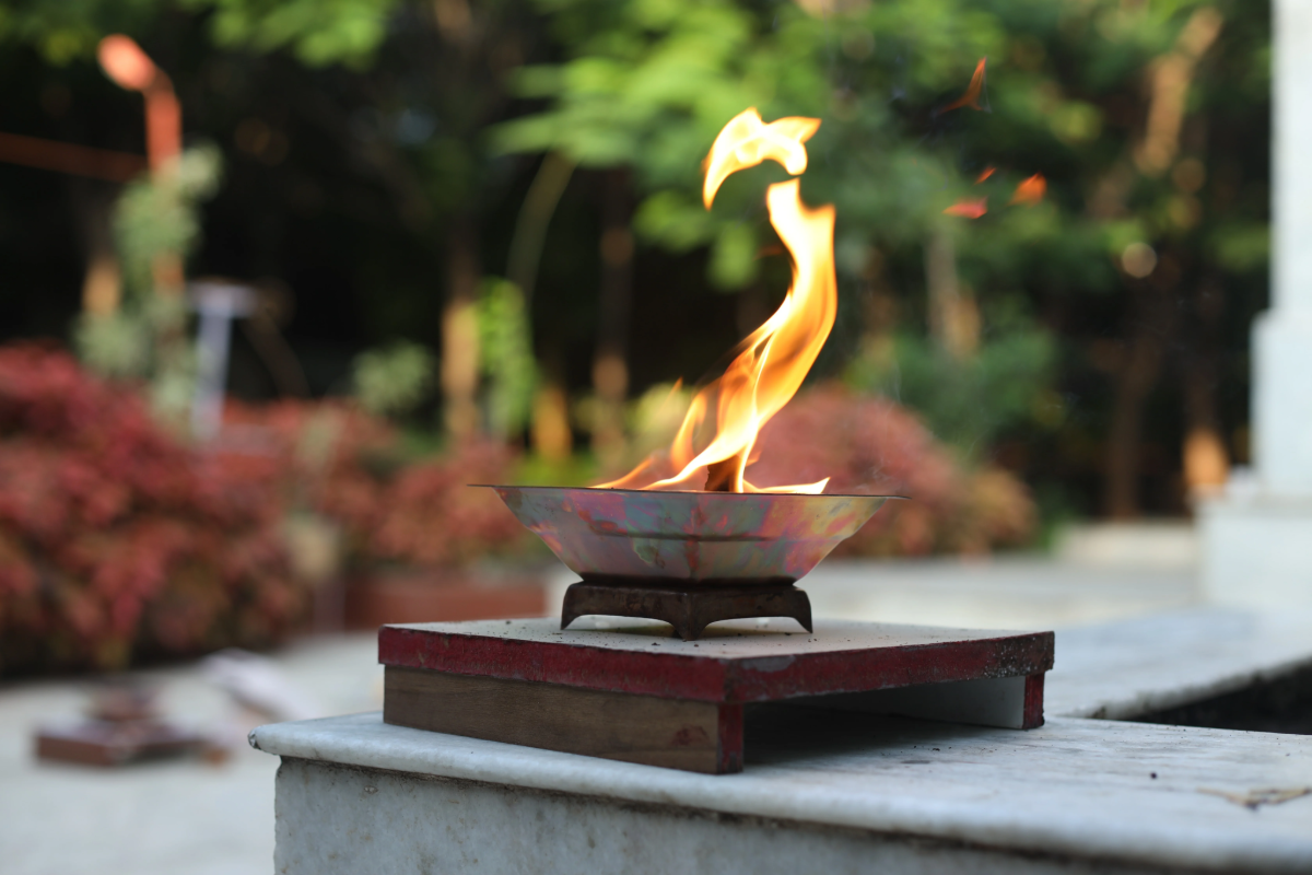 Agnihotra copper vessel with flame